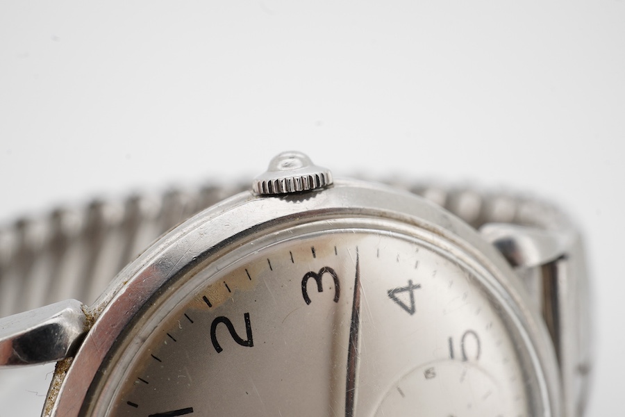 A gentleman's late 1940's stainless steel Omega automatic wrist watch, with Arabic dial and subsidiary seconds, case diameter 33mm, on an associated flexible strap. Condition - poor to fair